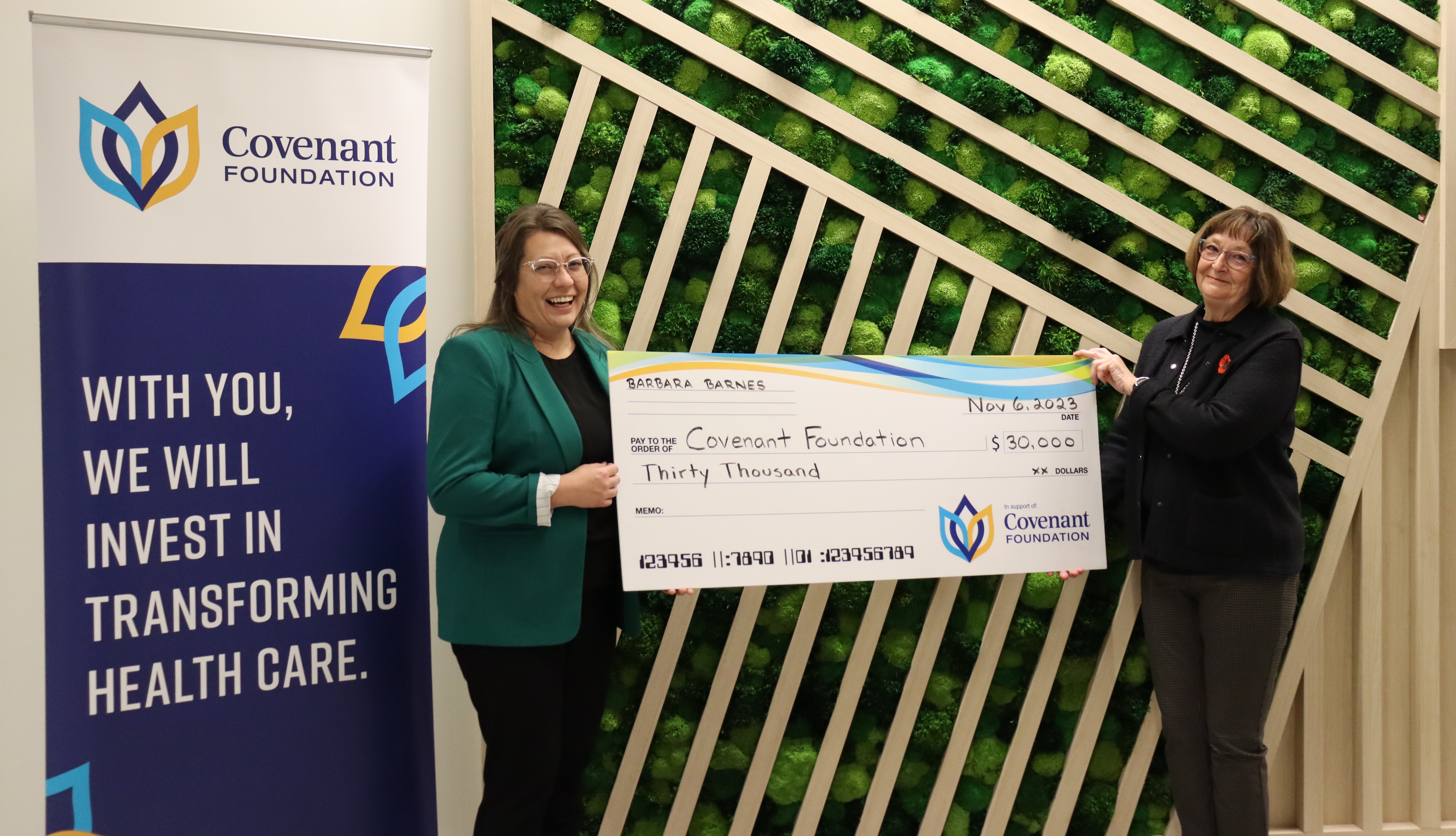 Barbara Barnes, Covenant Foundation Lottery bonus prize winner, presents Covenant Foundation Director of Philanthropy Sara Solowan with a giant cheque for $30,000